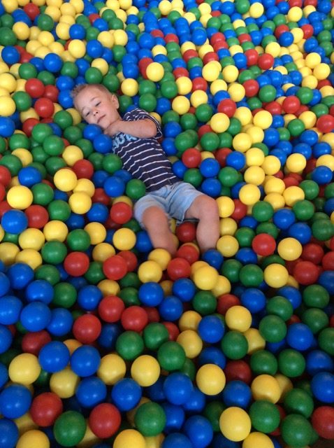 Photo of Hiatt laying in play balls